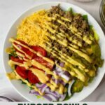 Burger Bowl of cooked ground beef, chopped pickles, shredded cheddar cheese, halved grape tomatoes, sliced red onion and chopped romaine lettuce drizzled with Burger Sauce Dressing with Healthy Mom Healthy Family logo.