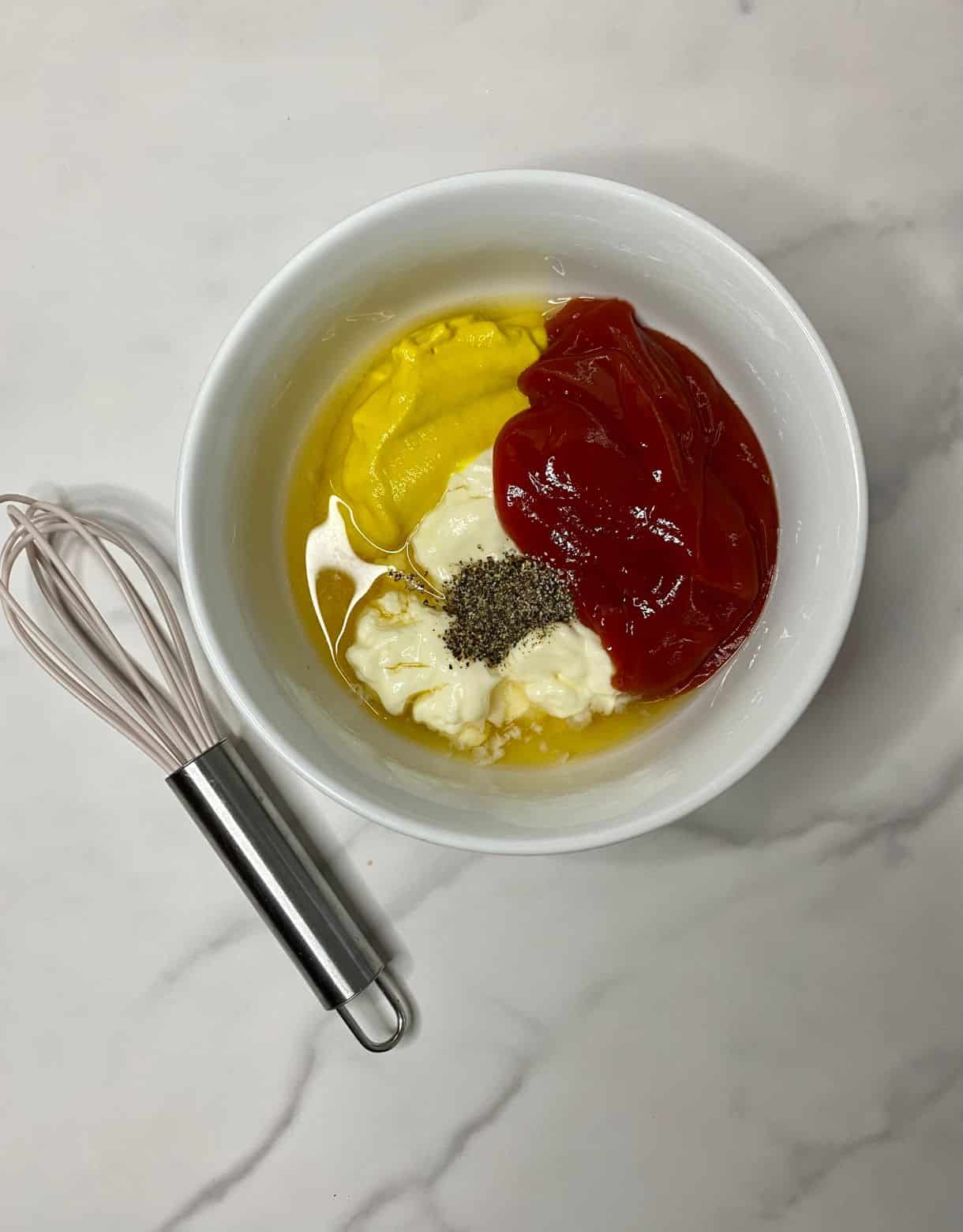 Ingredients for Burger Bowl Dressing in a bowl but not mixed.