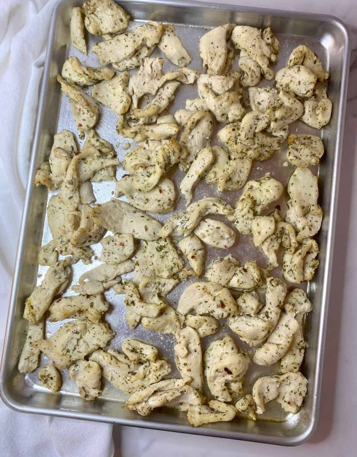 Sheet Pan with cooked Mediterranean Chicken Tray Bake.