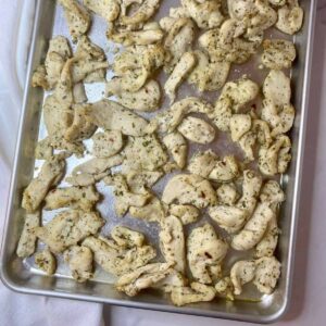 Sheet pan with cooked Mediterranean Chicken Tray Bake.