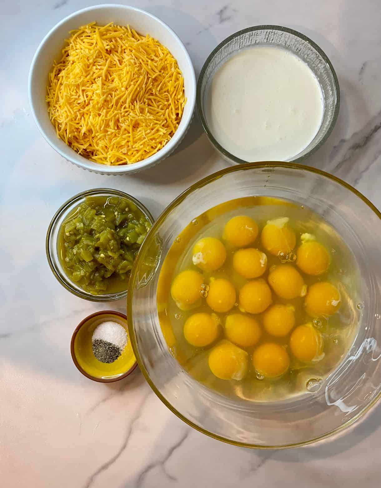 Ingredients for Green Chile Egg Casserole. Eggs, heavy cream, shredded cheddar cheese, green chiles, salt and pepper.