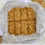 A pan of No-Bake Peanut Butter Granola bars on a cutting board with the Healthy Mom Healthy Family logo.