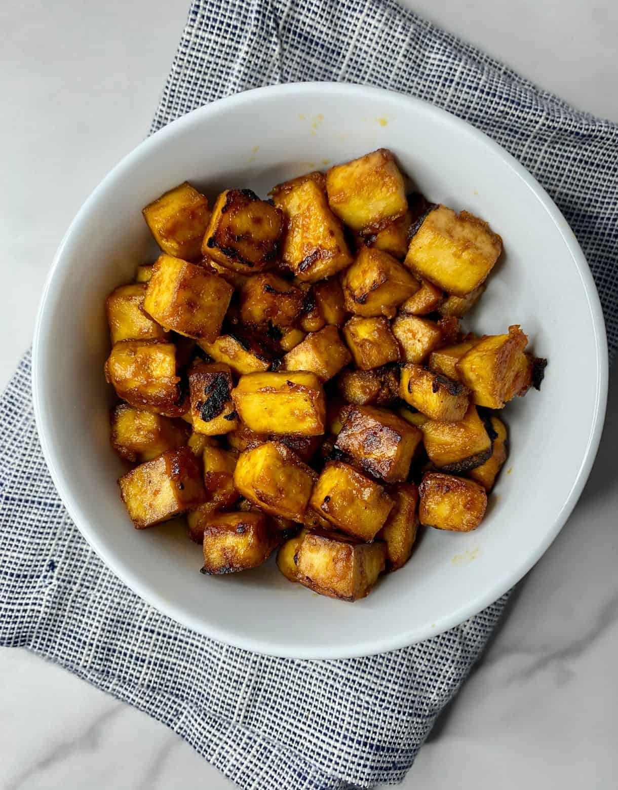 A bowl of baked Sesame Tofu.