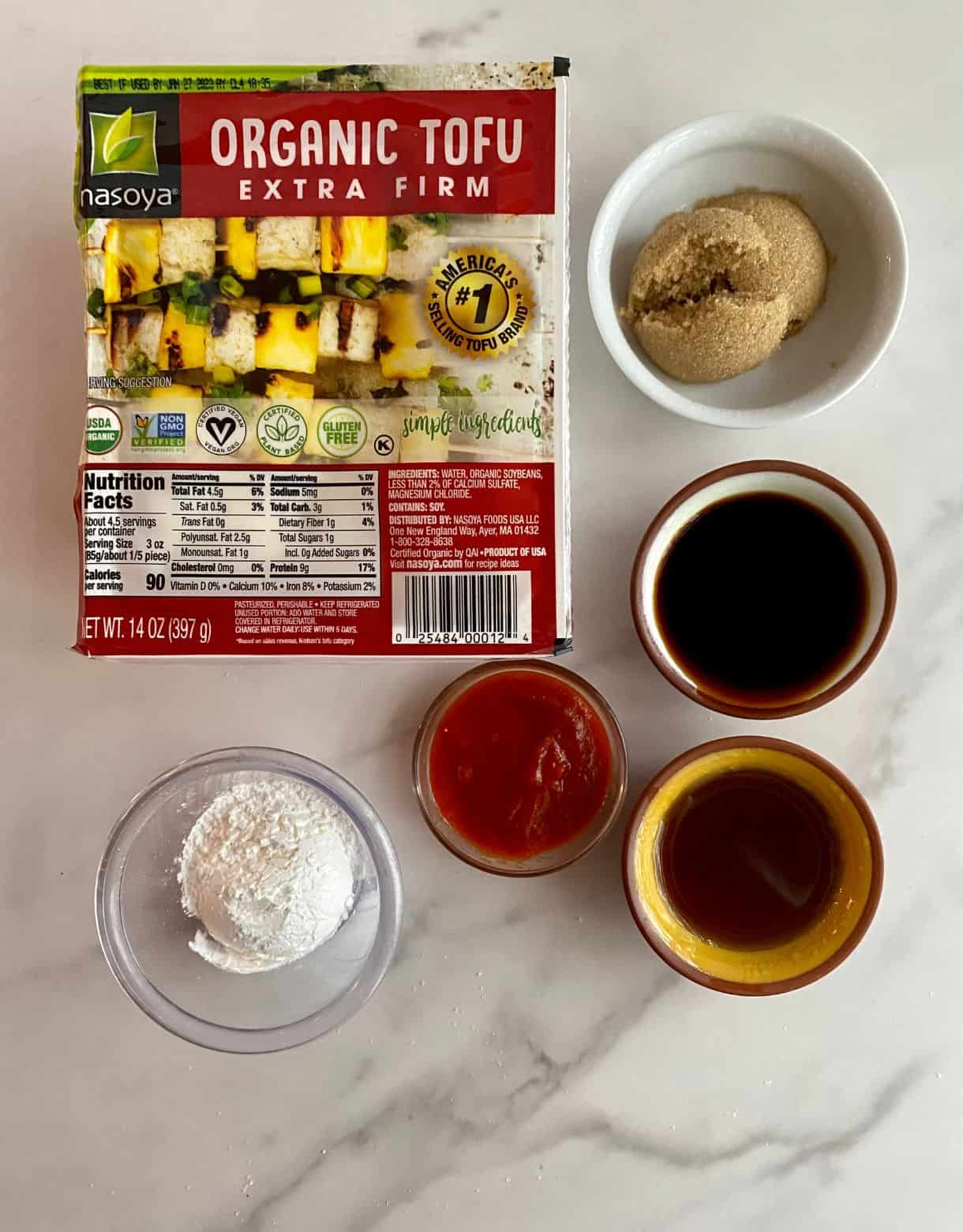 A block of extra firm tofu, cornstarch, brown sugar, soy sauce, sesame oil and sriracha sauce.