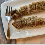 Two slided cooked pork tenderloins on a platter with the Healthy Mom Healthy Family logo.