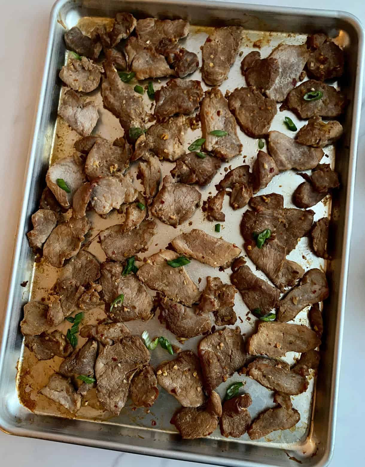 A sheet pan of cooked Vietnamese Lemongrass Pork.
