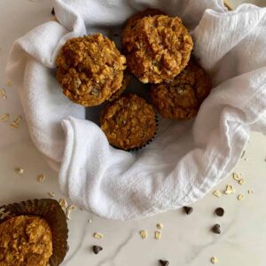 A basket of Healthy Pumpkin Chocolate Chip Muffins.