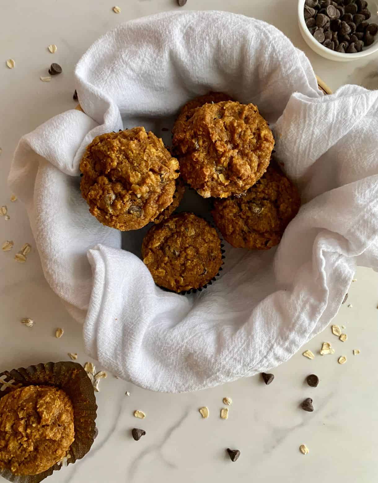 A basket of Healthy Pumpkin Chocolate Chip Muffins.