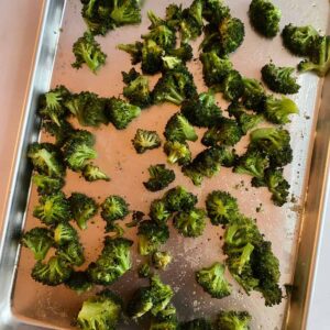 A sheet pan with roasted broccoli.