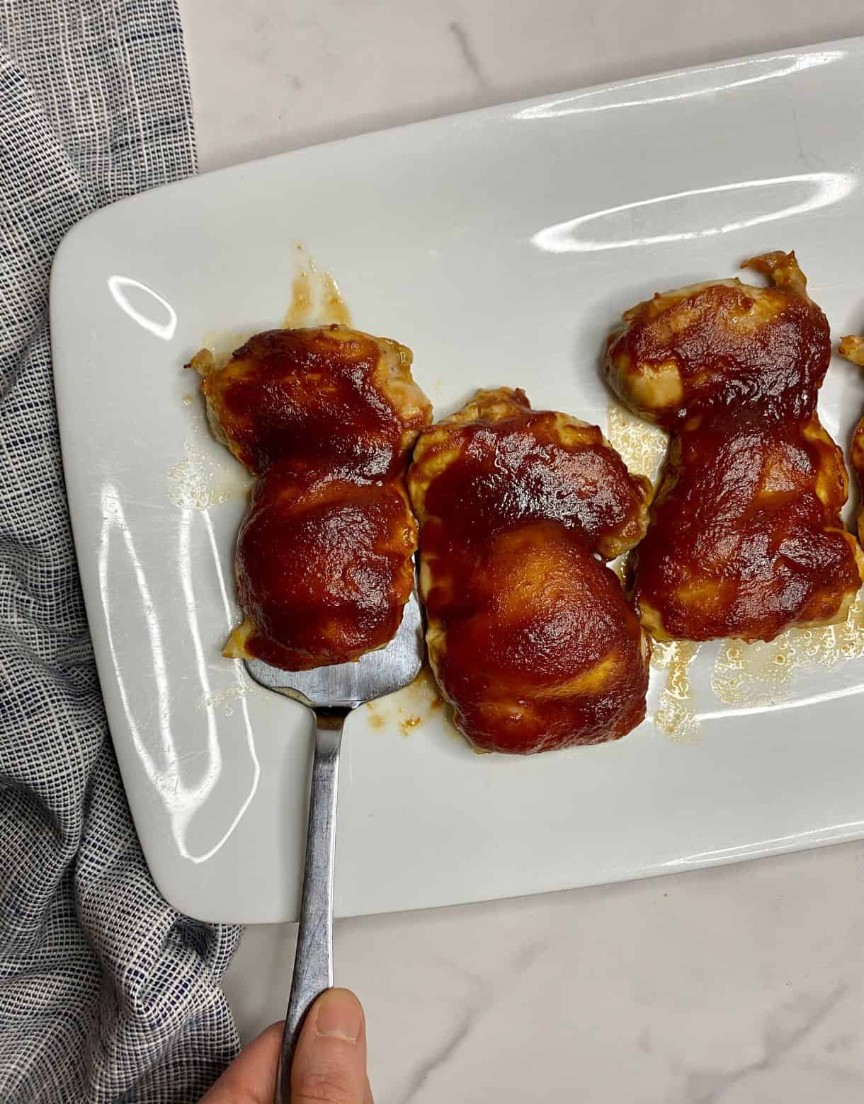 A platter with cooked Baked BBQ Chicken Thighs