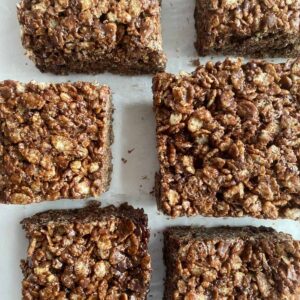 Six Chocolate Rice Krispie Treats cut into squares.