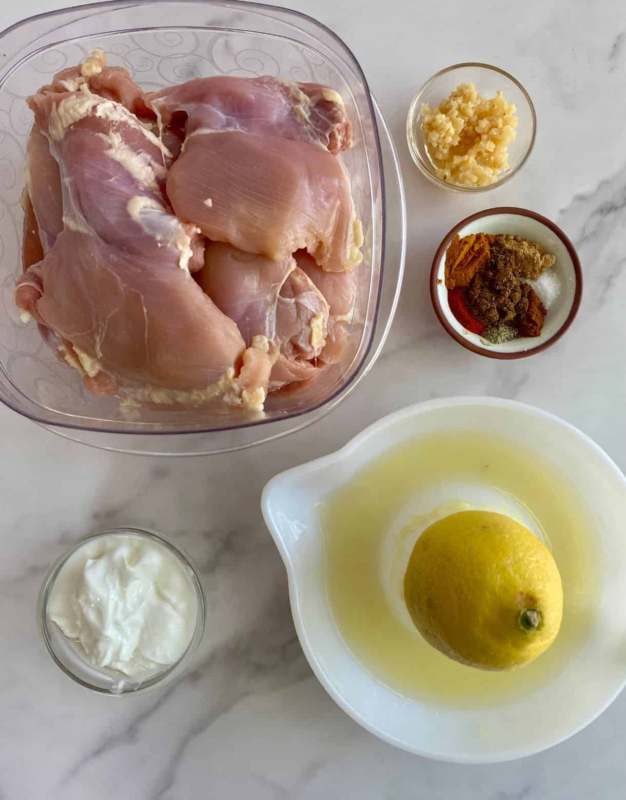 Raw boneless skinless chicken thighs, lemon juice, Greek yogurt, minced garlic and spices.