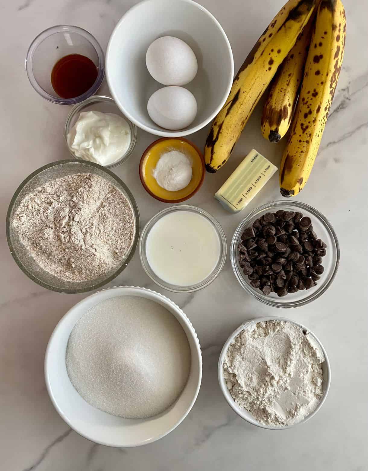 Whole wheat flour, all-purpose flour, eggs, vanilla, butter, greek yogurt, milk, sugar, bananas, baking soda and chocolate chips.