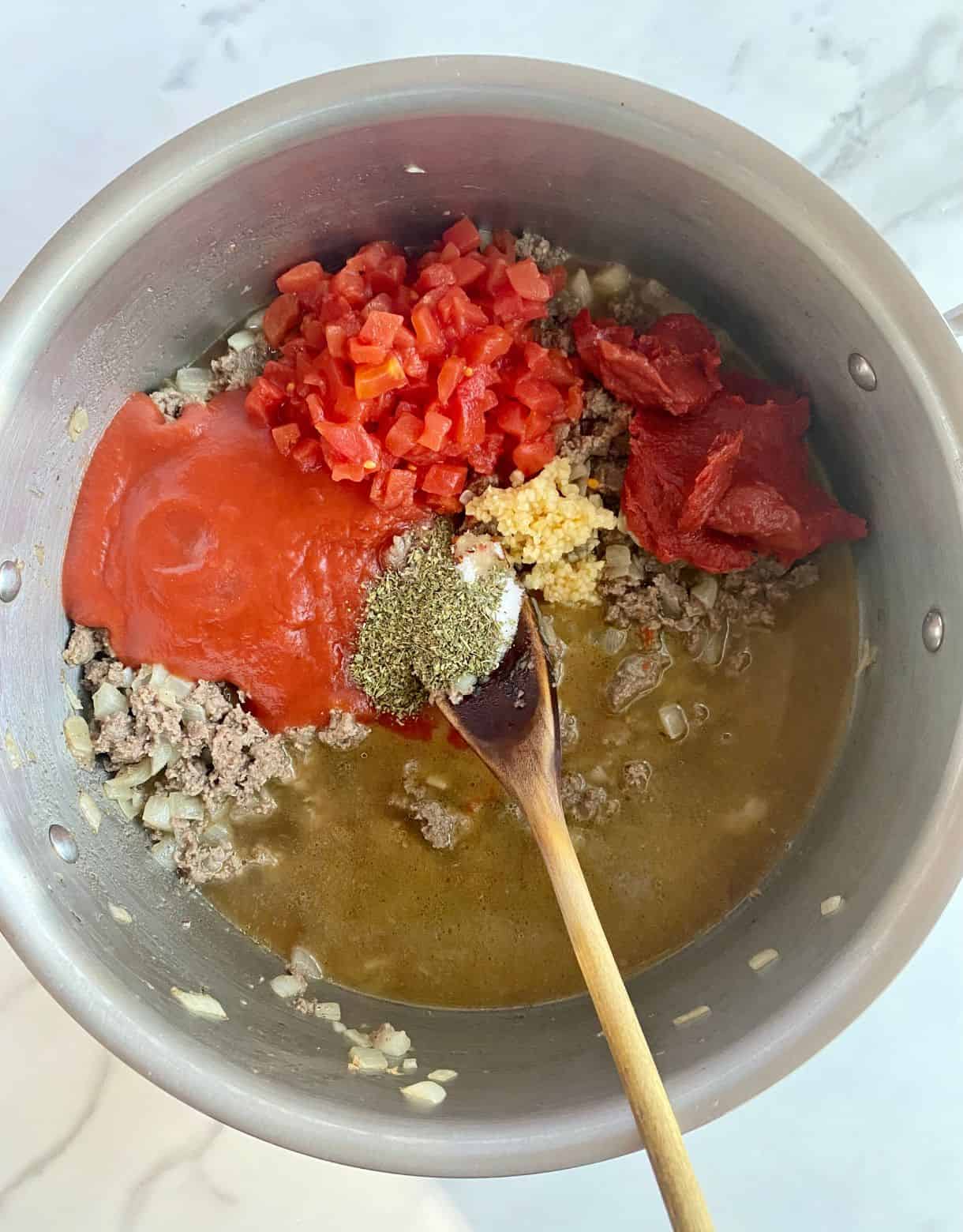 A pot with all the ingredients added for Healthy Lasagna Soup, but not stirred.