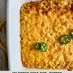 A pan of macaroni and cheese topped with jalapenos.