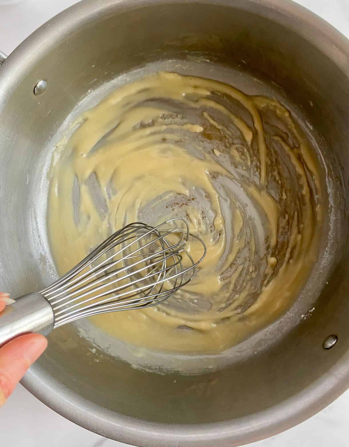 A pan with melted butter and flour whisked into it.