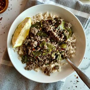 A Lebanese Grape Leaves Bowl with a wedge of lemon.