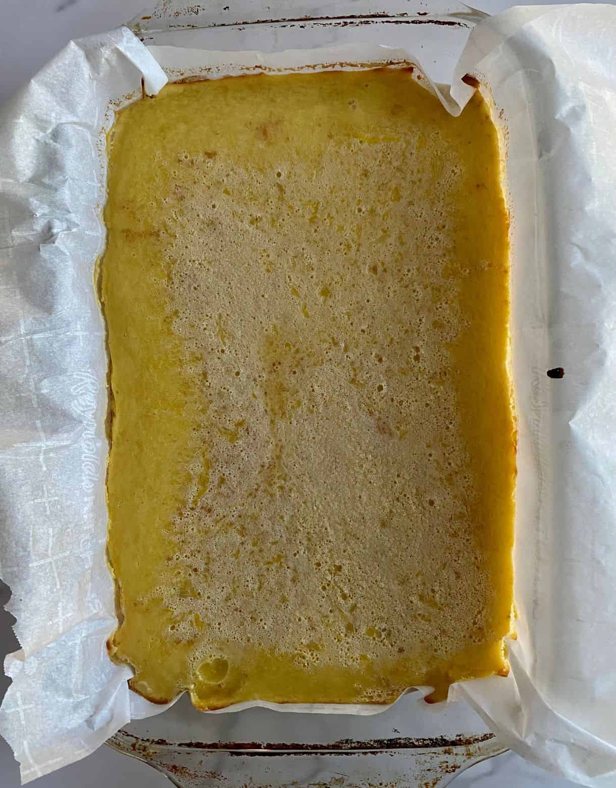 A pan of baked Lemon Bars with a graham cracher crust.