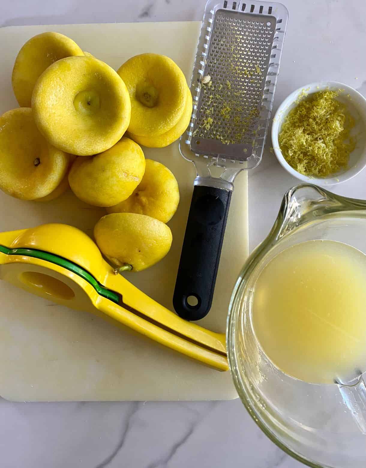 A bunch of discarded lemons and the juice and zest obtained from the lemons.