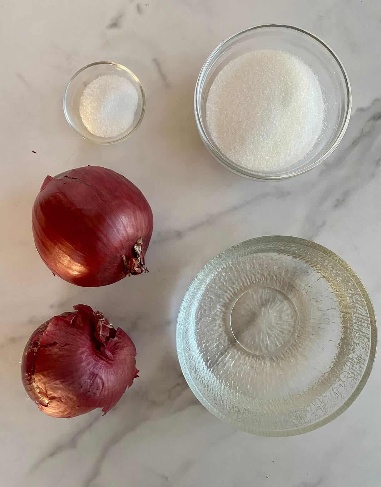 Ingredients for Mexican Pickled Onions. Red onions, white vinegar, salt and sugar.