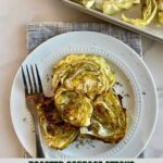 A plate with cooked Oven Roasted Cabbage Steaks and a fork.