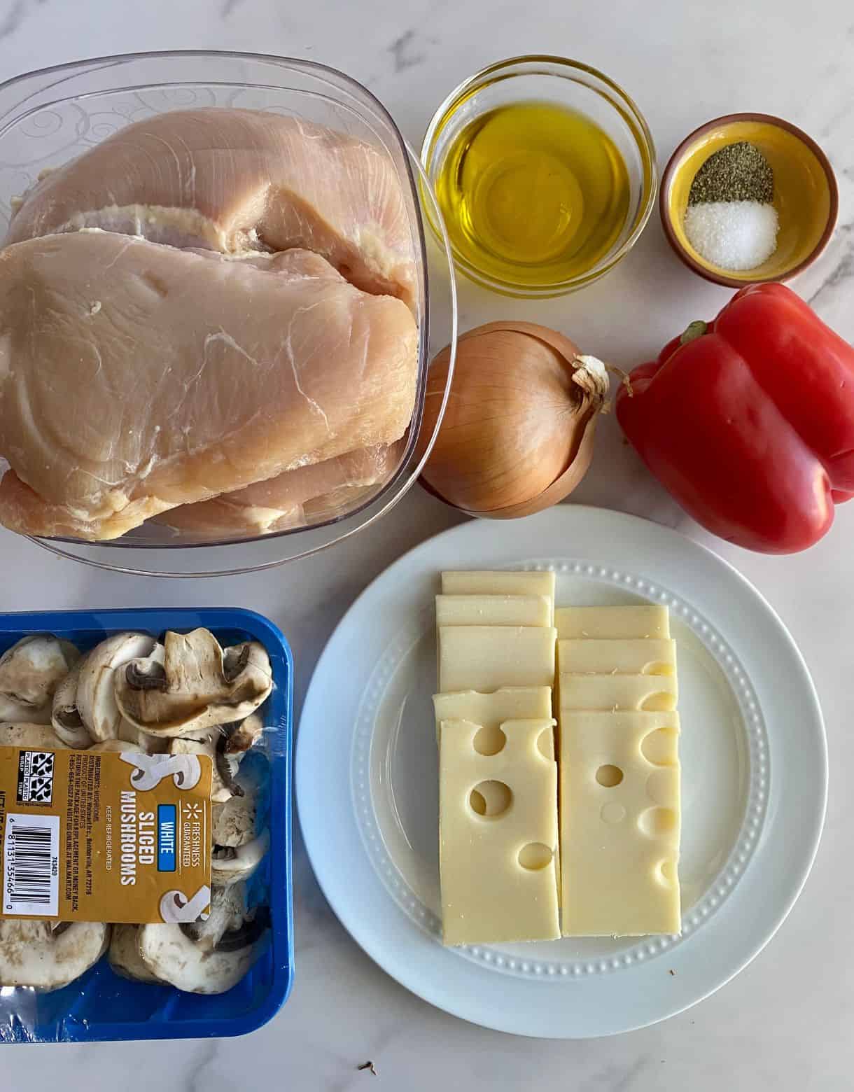 Ingredients for Chicken Philly Cheesesteak. Chicken breast, olive oil, salt, pepper, onion, bell pepper, mushrooms and swiss cheese.