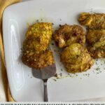 A platter with 3 cooked Garam Masala Chicken Thighs.