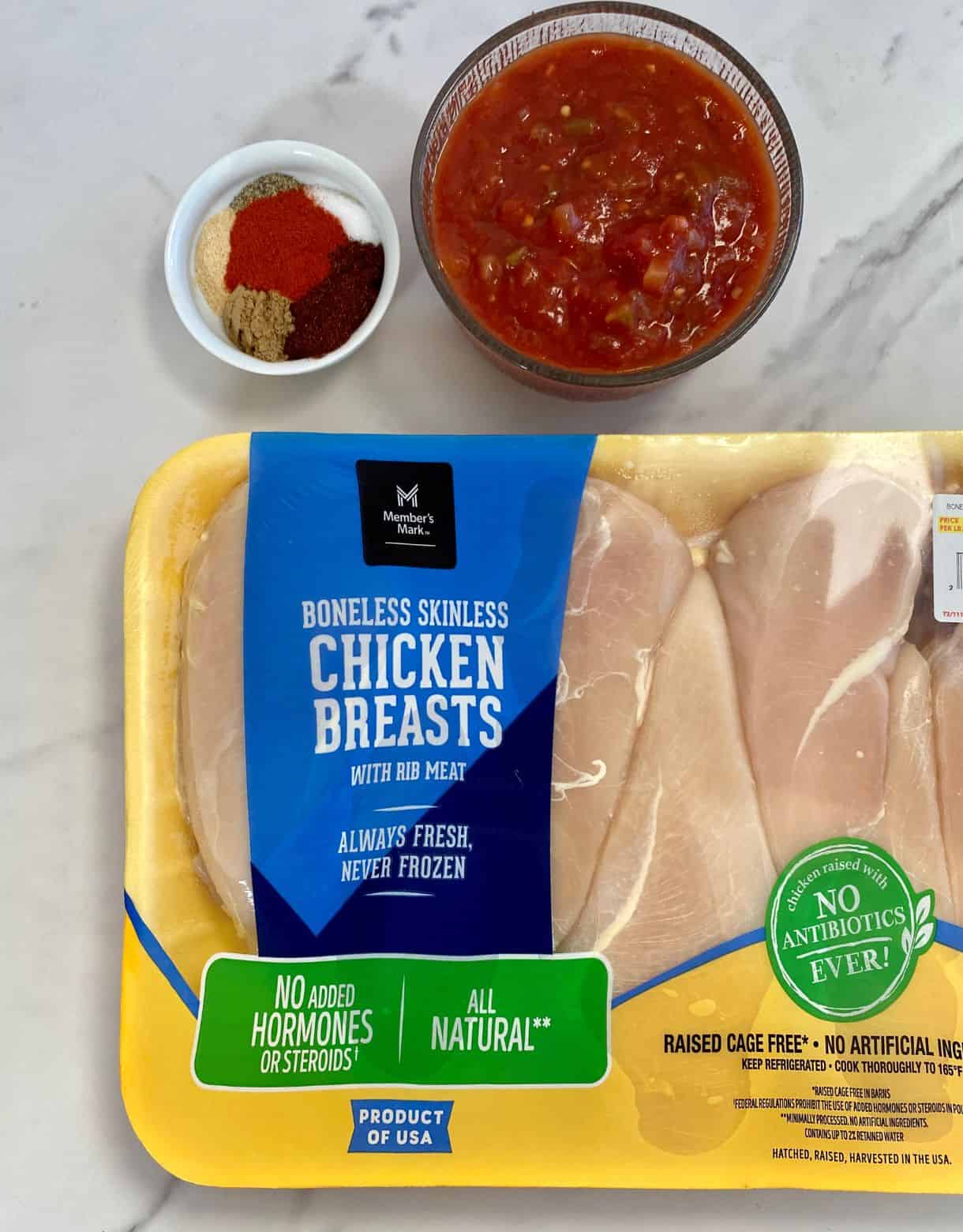 Raw chicken breasts, spices and salsa.
