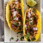 Two Slow Cooker Chicken Tacos on a plate with chopped raw and onion cilantro and a wedge of lime and the Healthy Mom Healthy Family logo.