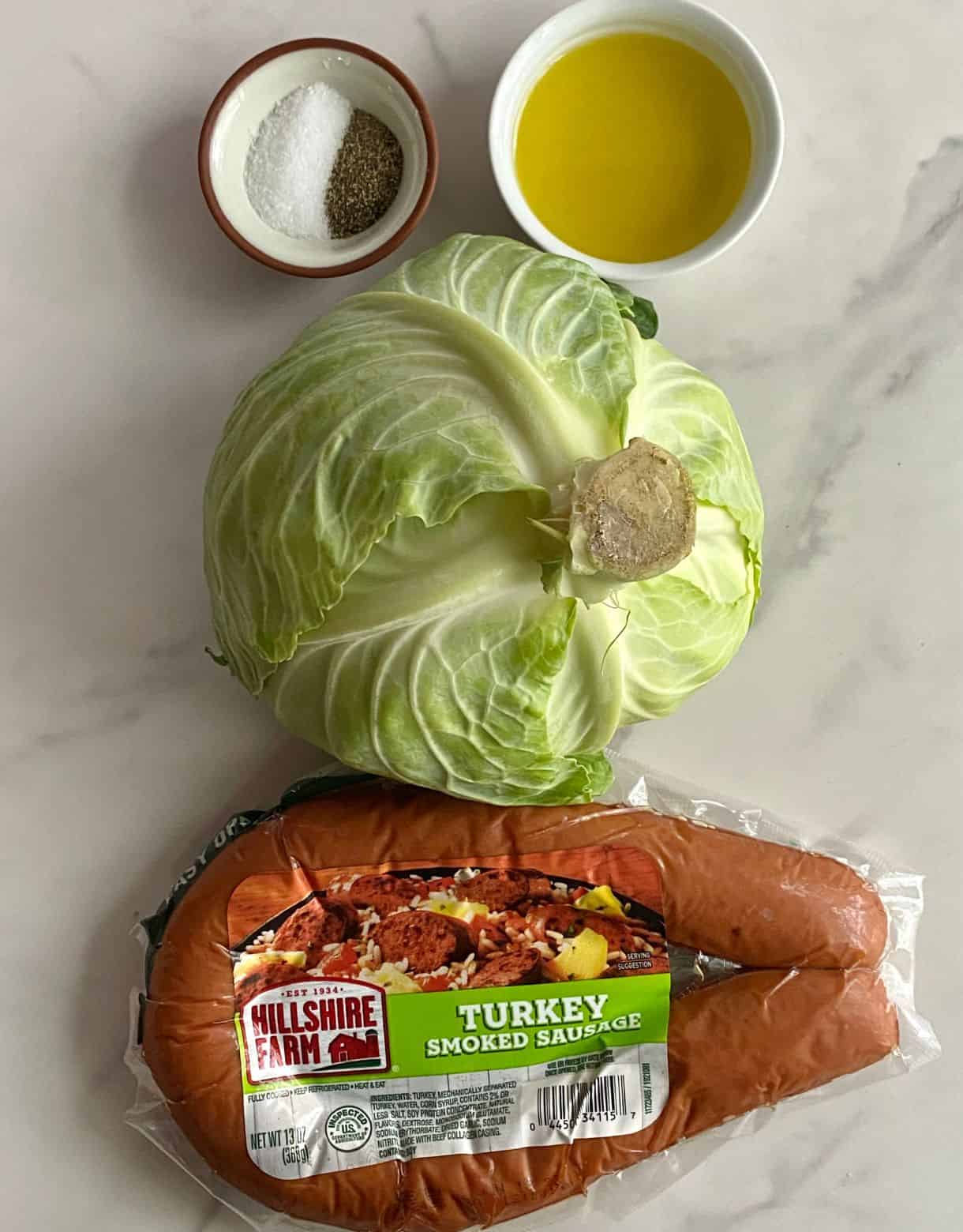 Ingredients for Southern Fried Cabbage with Sausage. Smoked sausage, green cabbage, olive oil, salt and pepper.