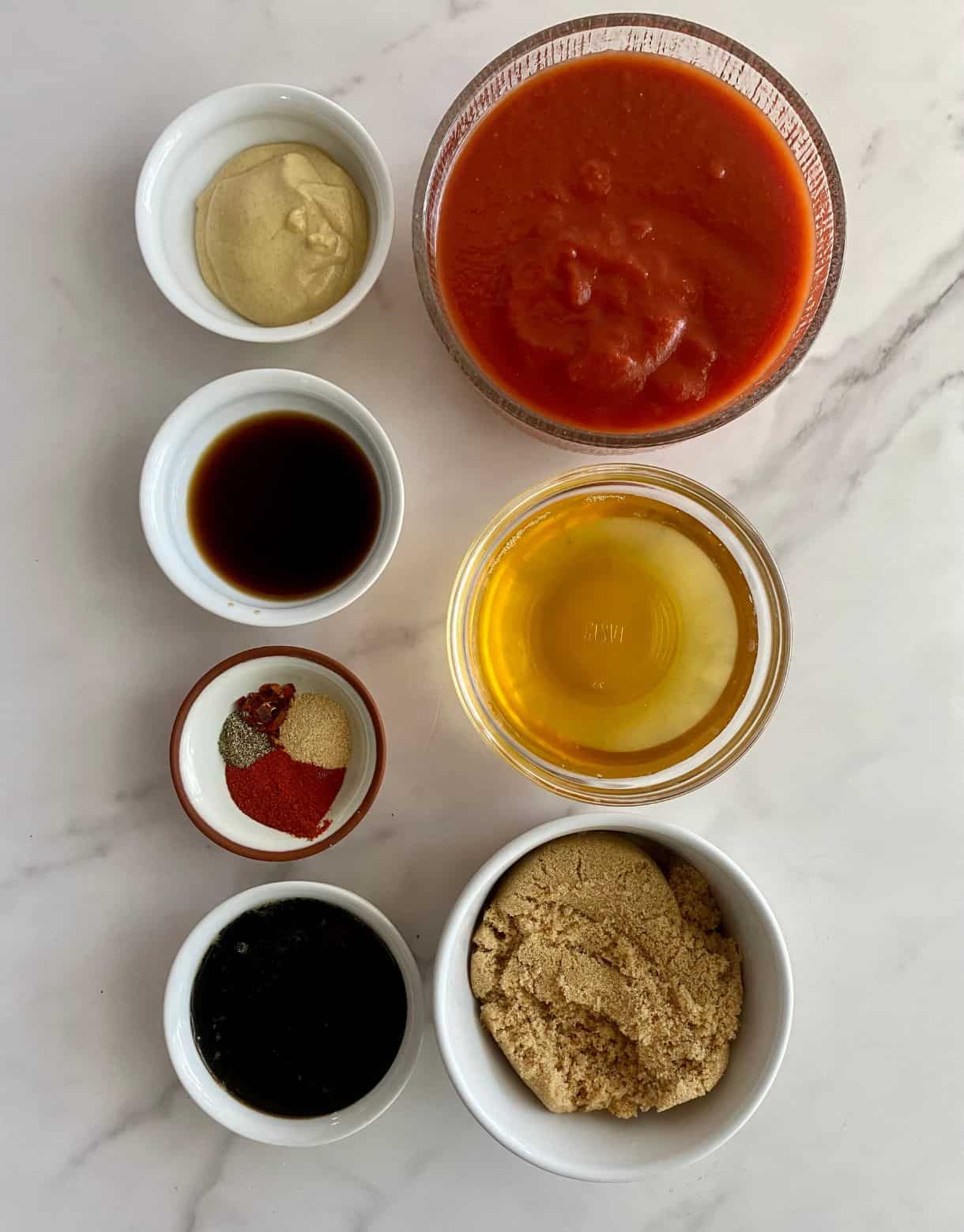 Tomato sauce, vinegar, dijon mustard, Worcestershire sauce, spice, brown sugar and liquid smoke.