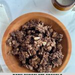 A bowl of Dark Chocolate Granola and a pitcher of almond milk.