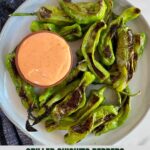 A plate of Grilled Shishito Peppers with Sriracha Mayo dipping sauce.