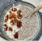 A bowl of Keto Chia Pudding topped with nuts and shredded coconut.