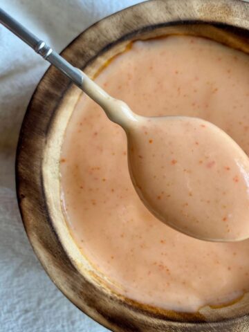 A bowl of Spicy Sriracha Mayo with a spoon.