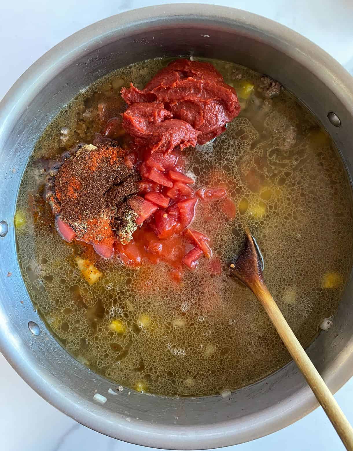 A pot with all of the ingredients added for Sweet and Spicy Chili but not yet stirred.