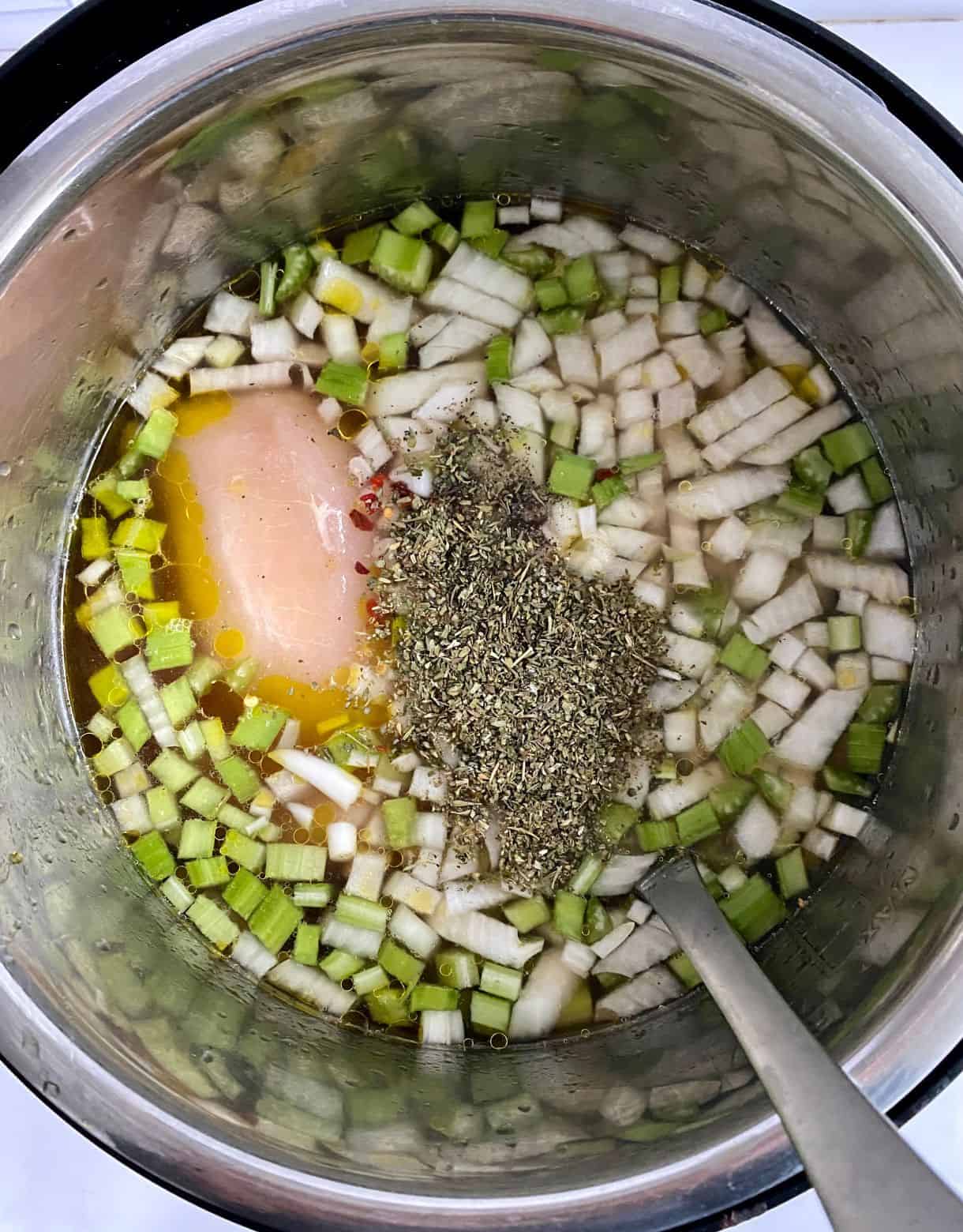 A slow cooked with broth, spices, vegetables and raw chicken added.