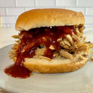 Coca-Cola Pulled Pork on a bun with BBQ sauce.