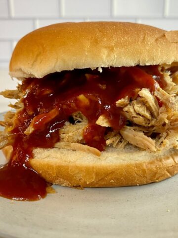 Coca-Cola Pulled Pork on a bun with BBQ sauce.