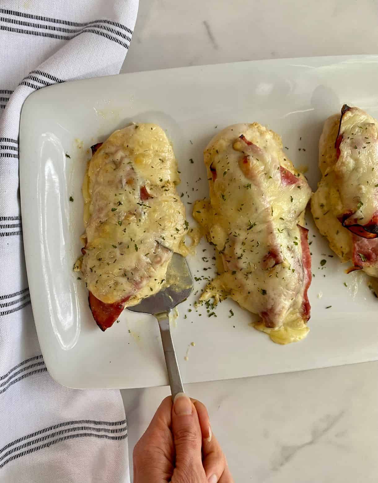 A platter with cooked Healthy Chicken Cordon Bleu.