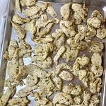 A sheet pan with cooked Mediterranean Chicken Tray Bake.