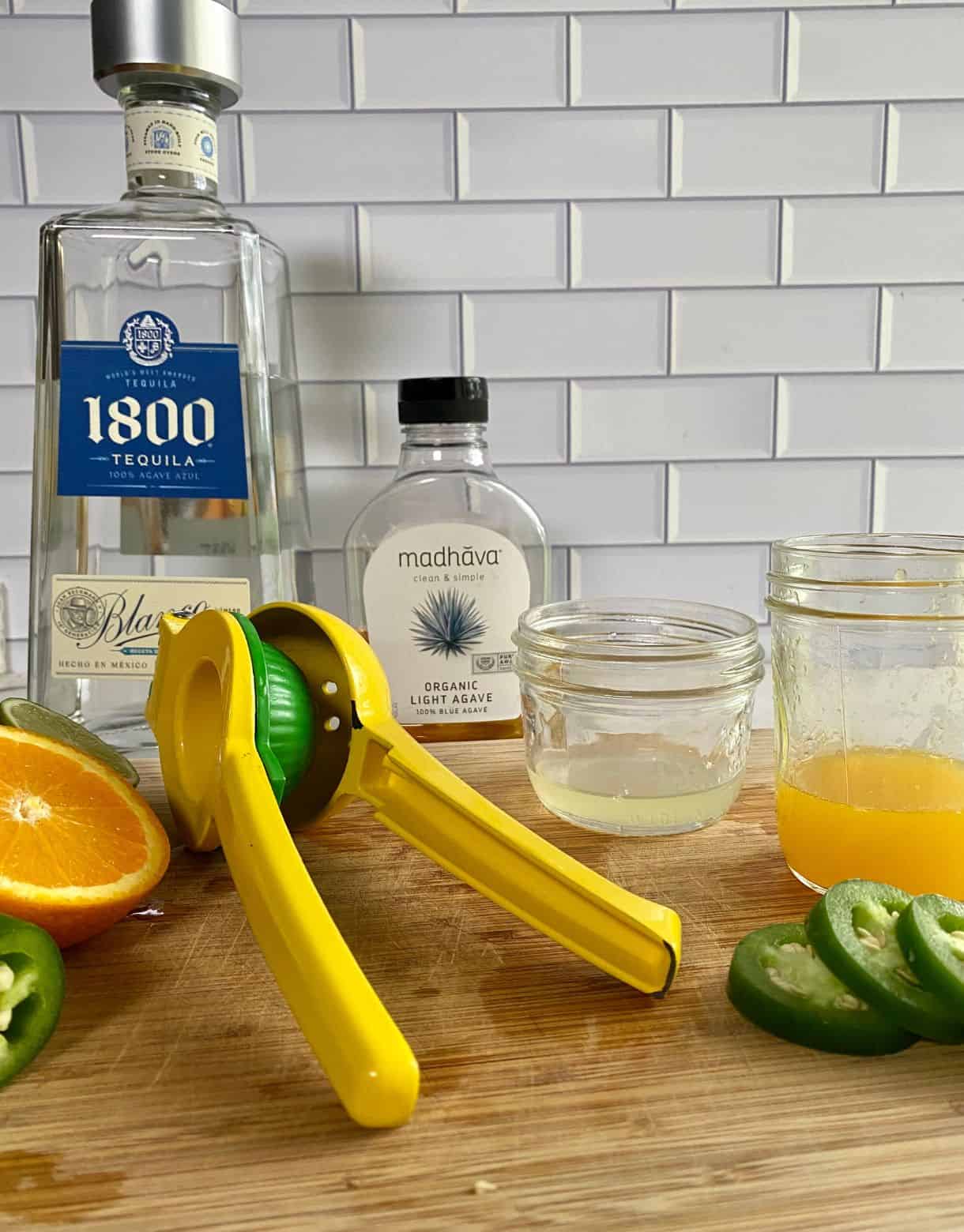 Silver tequila, juice press, agave, lime juice, orange juice and jalapeno slices.