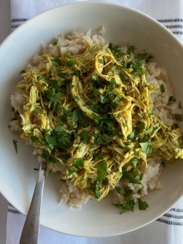 A bowl of Slow Cooker Curry with Coconut Milk over cauliflower rice.