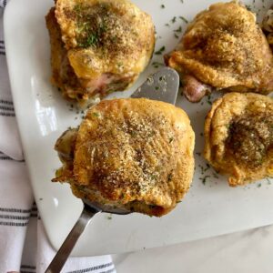 A platter with 4 cooked Southern Baked Chicken Thighs.