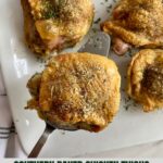 A platter with 4 cooked Southern Baked Chicken Thighs.