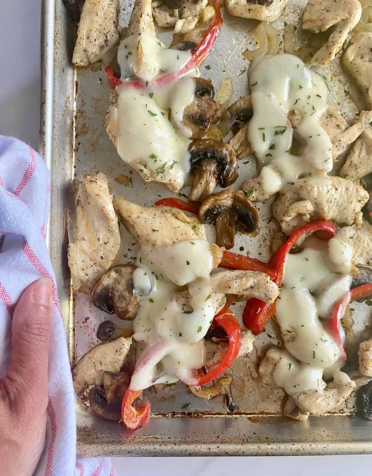 A sheet pan with cooked Chicken Philly Cheesesteak.
