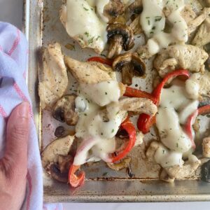 A sheet pan with cooked Chicken Philly Cheesesteak.
