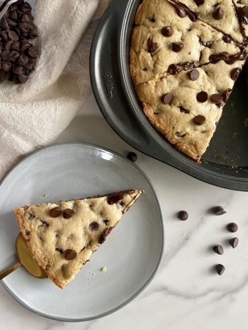 A cooked Deep Dish Cookie Pie with a piece cut out of it.