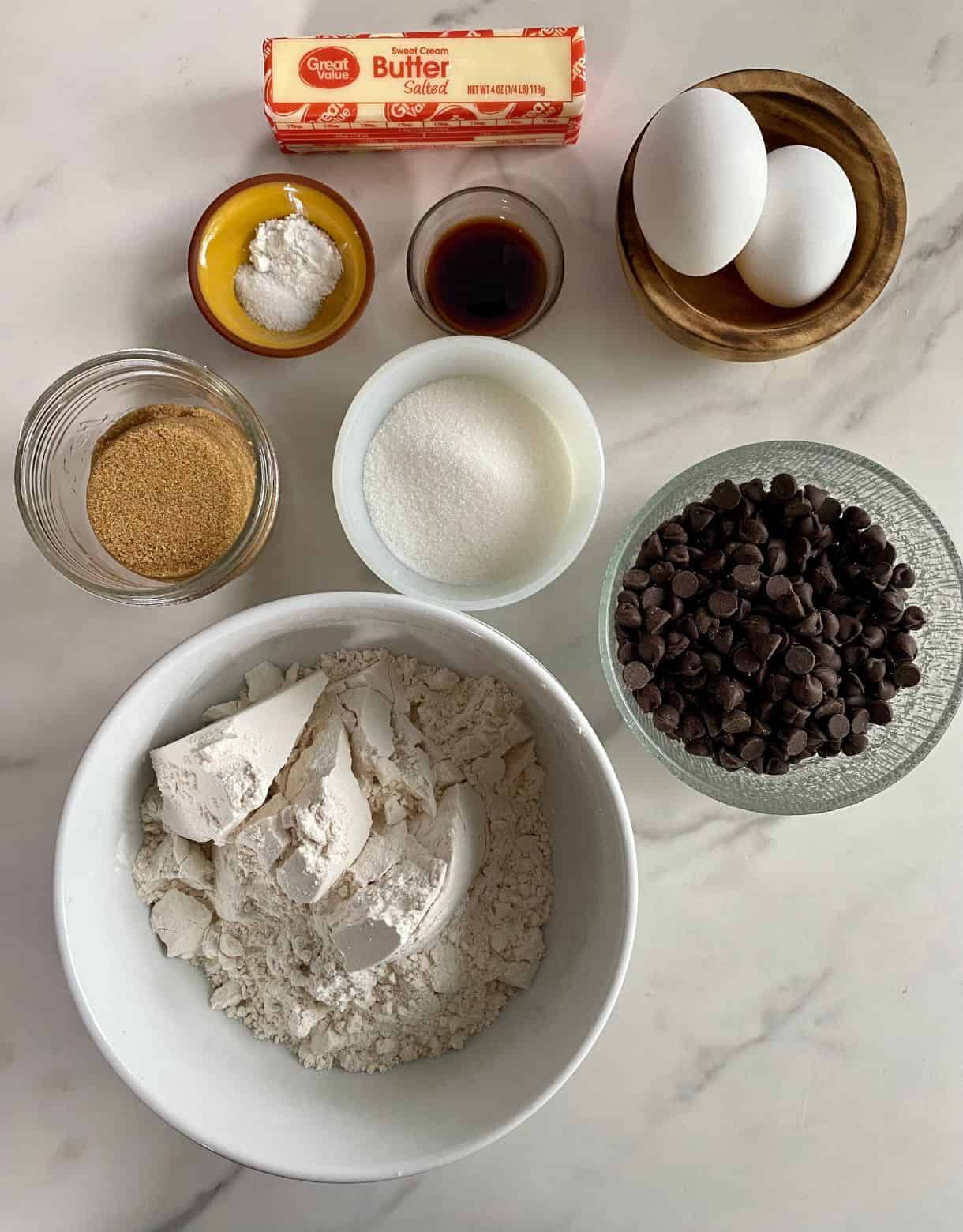 Flour, sugar, brown sugar, chocolate chips, vanilla, eggs, butter, salt and baking soda.