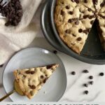 A cooked Deep Dish Cookie Pie with a piece cut out of it.